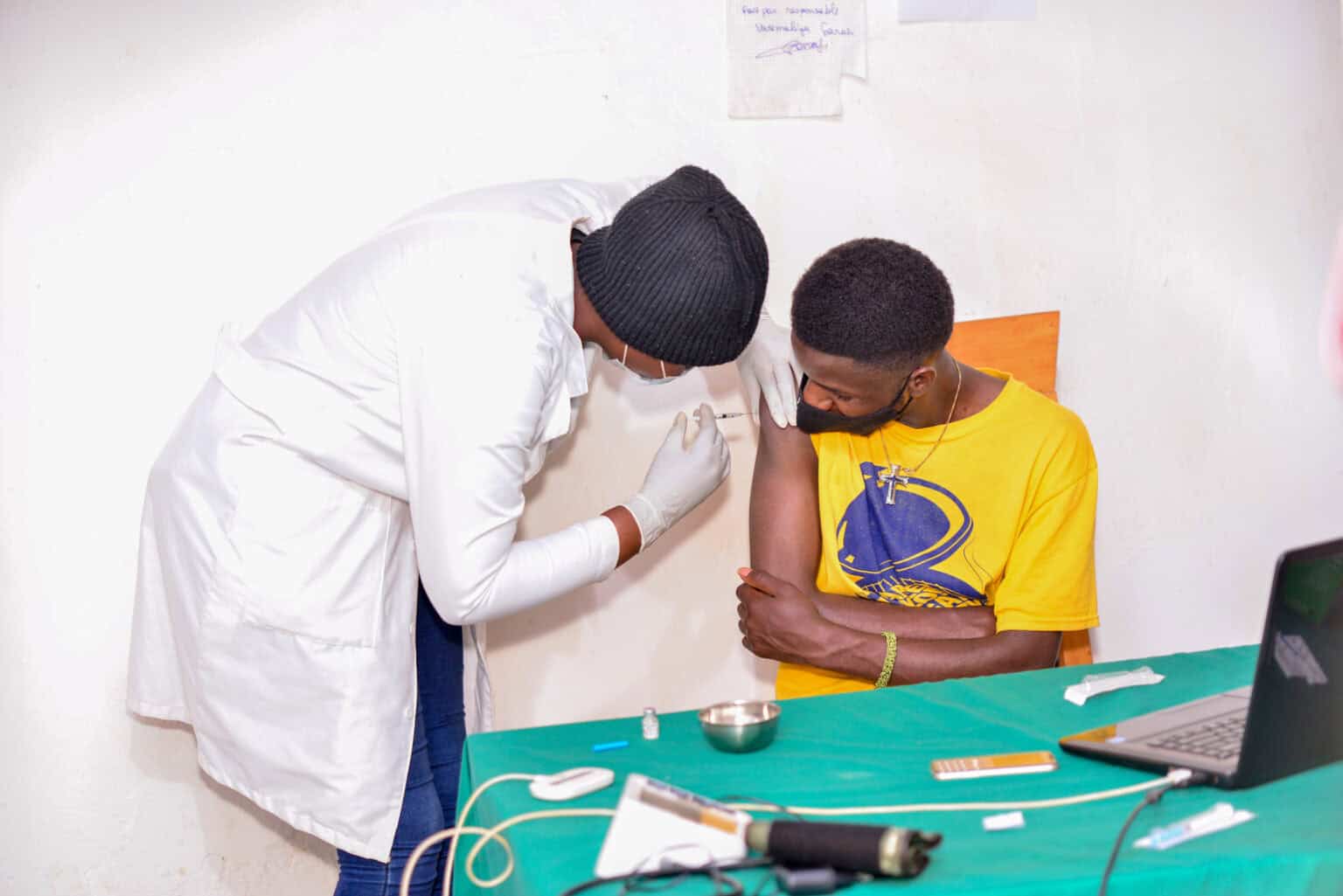 A Rwandan youth receiving his covid 19 vaccine jab in kigali