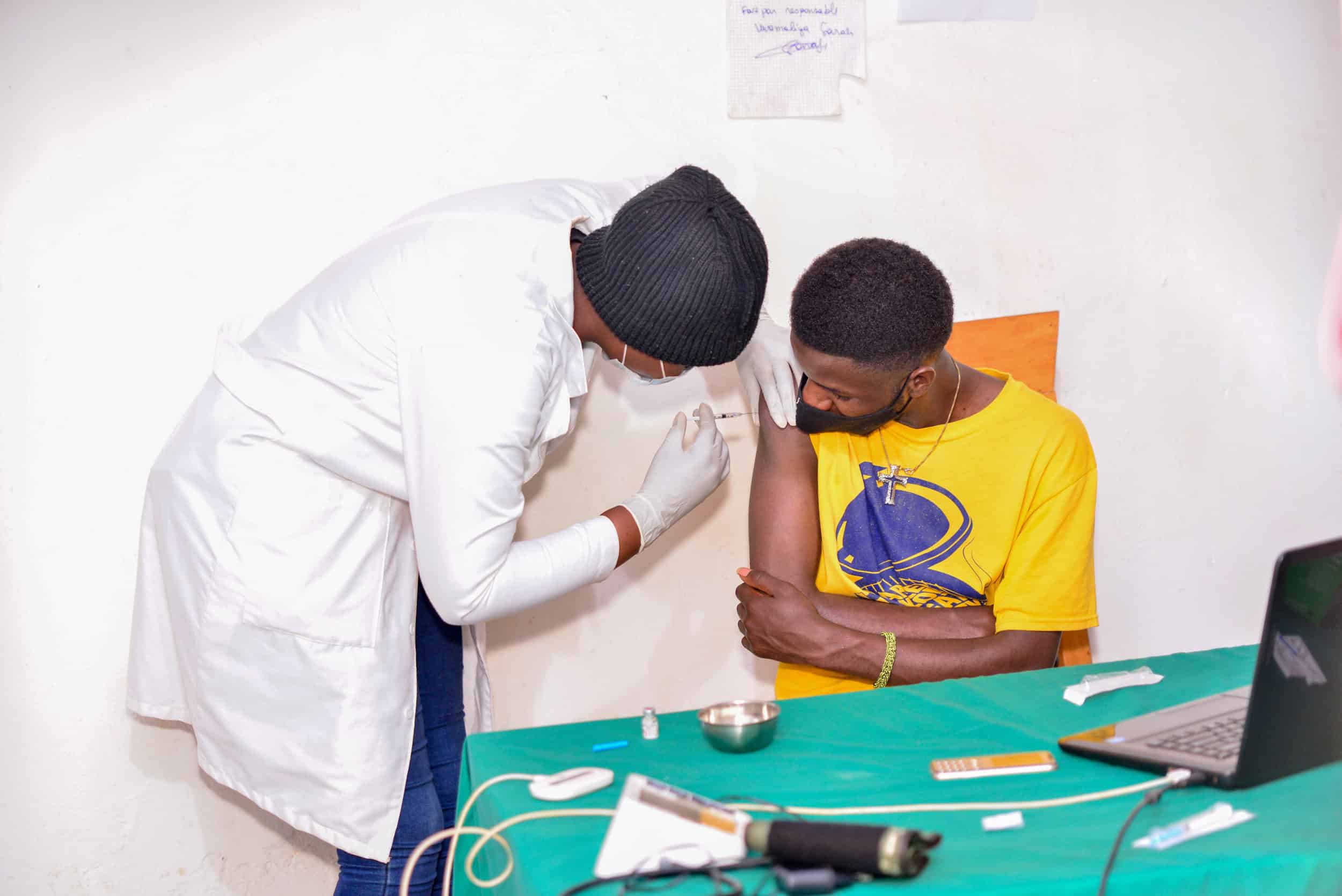 A Rwandan youth receiving his covid 19 vaccine jab in kigali