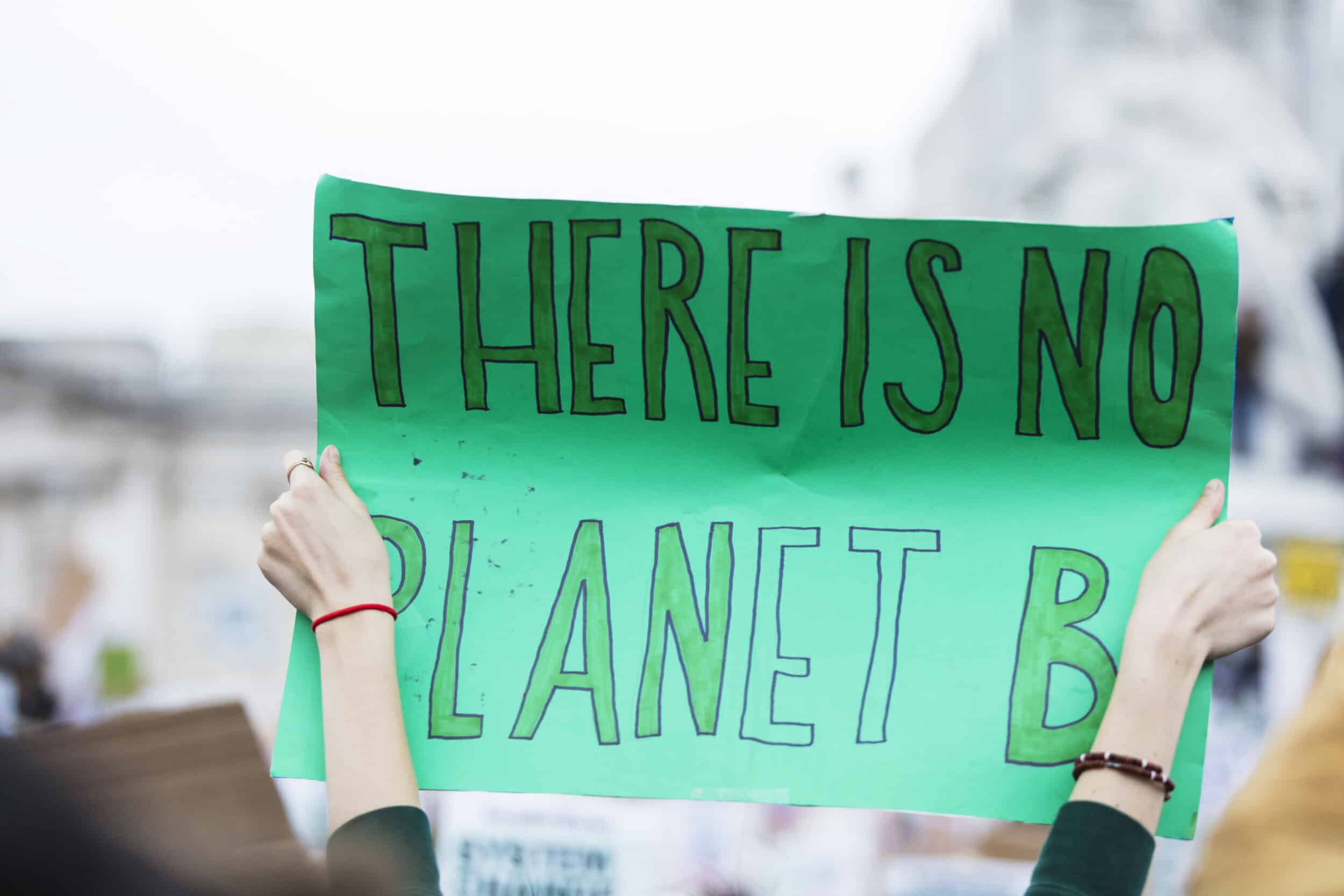 People with banners protest as part of a climate change march