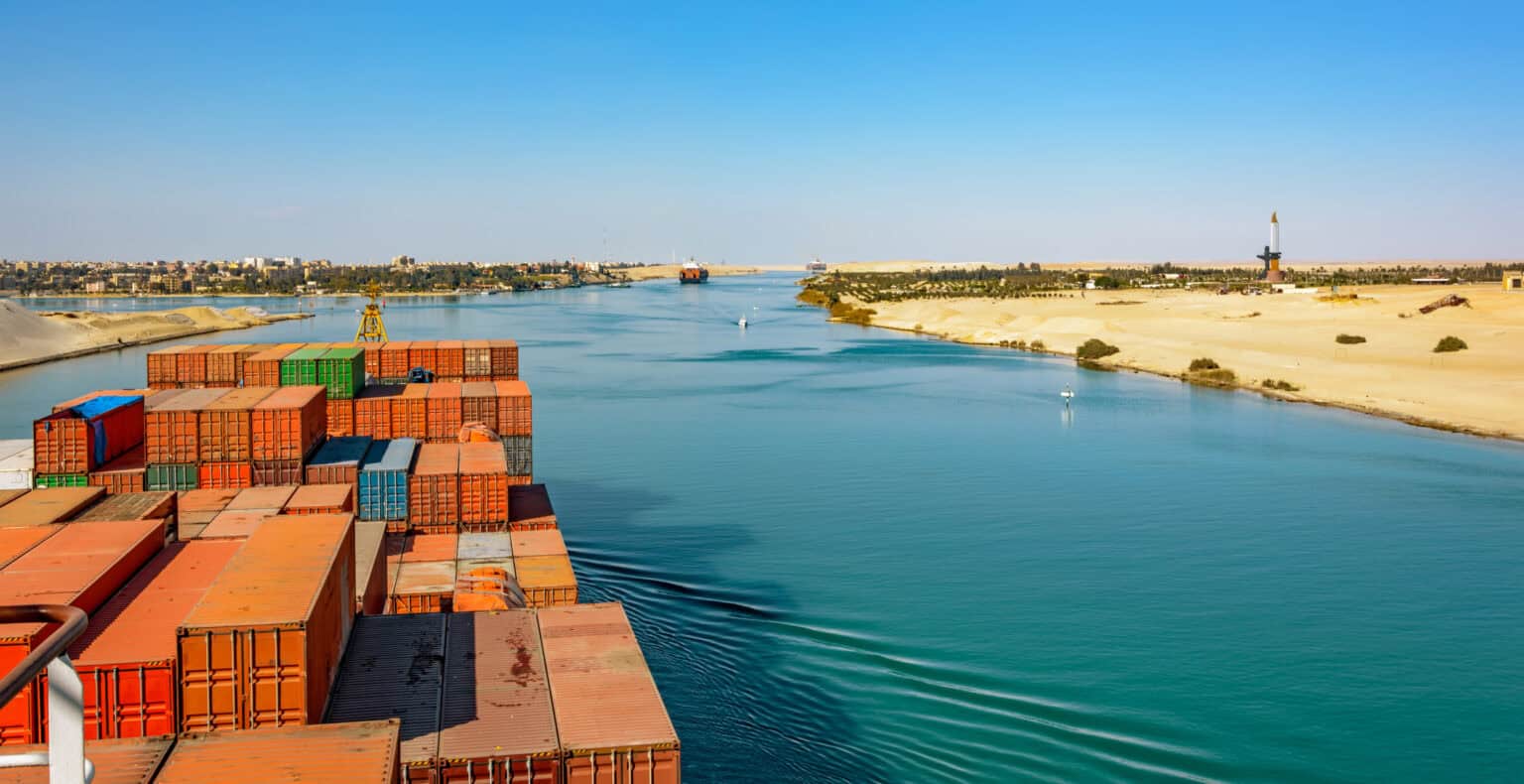 Industrial container ship passing through Suez Canal with ship's