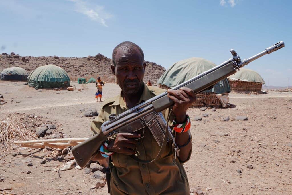 Losike. Security guard in Sarima watching over cattle and people.