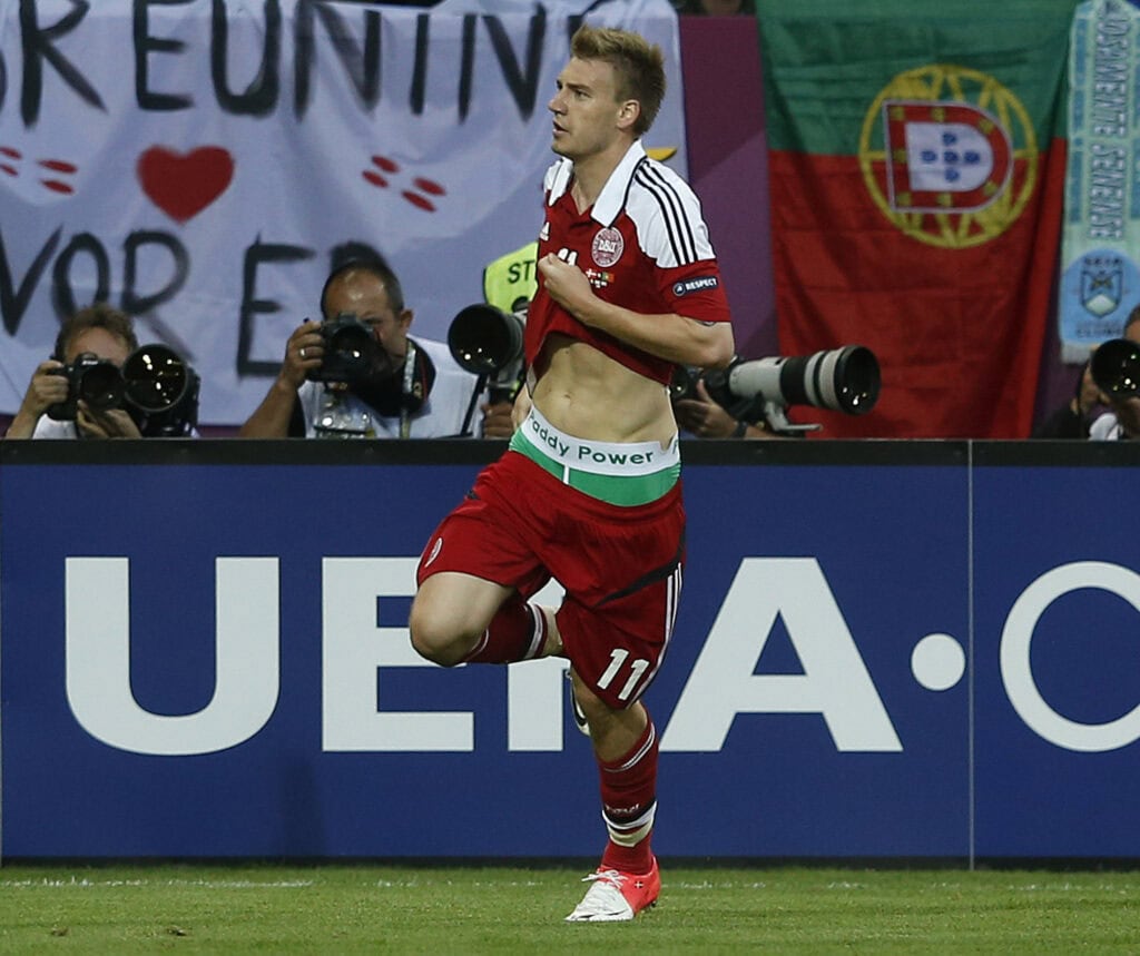 Denmark's Bendtner runs on the pitch displaying the name of Irish bookmaking firm Paddy Power on the waistband of his underpants during their soccer match against Portugal in Lviv